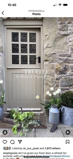 an image of a front door with flowers in buckets