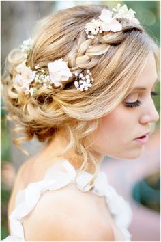 a woman with blonde hair and flowers in her hair