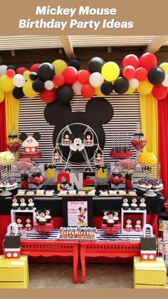 a mickey mouse birthday party with balloons and decorations