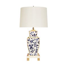 a blue and white vase lamp with a white shade