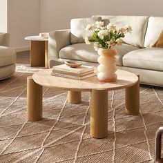 a living room with two couches and a coffee table in the middle on carpeted flooring