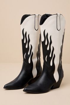 The Billini Zarina Black and Ivory Flame Knee-High Slip-On Western Boots are straight fire! These festival-ready pointed-toe boots are composed of lightly textured faux leather and feature a striking contrast, courtesy of the flame-shaped accents that begin at the Western-style seaming and trail up the 14"" knee-high shaft with a 13"" circumference. Pull tabs at the curved topline make for easy on and off! Available in whole sizes only. 2. 75" stacked block heel. Cushioned insole. Rubber sole ha Black Rhinestone Cowboy Boots, Cowboy Boot Design, Flame Cowboy Boots, Fire Boots, Knee High Cowboy Boots, Black Western Boots, Wedding Collage, Ankle Cowboy Boots, Black Cowboy Boots