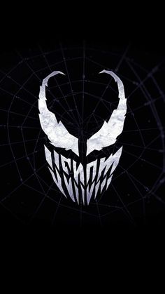 an image of a black and white logo with horns on it's face in the dark