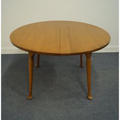 a wooden table sitting on top of a carpeted floor