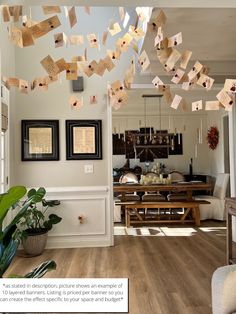 a living room filled with furniture and lots of papers hanging from it's ceiling