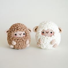 two crocheted sheep sitting next to each other