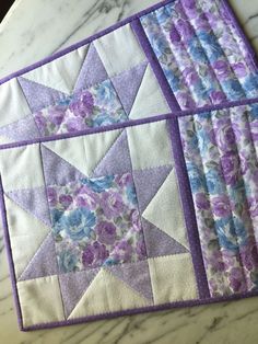 two quilts with purple and blue flowers on them