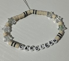 a beaded bracelet with the word capriga written in white and black beads