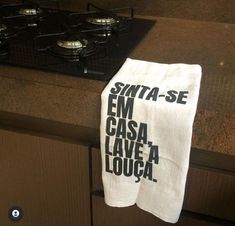a tea towel hanging on the side of a stove top oven burner in a kitchen