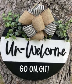 a sign that says, ur - welcome go on, git hanging from a tree