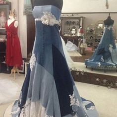 a dress that is on display in a room with mannequins and dresses