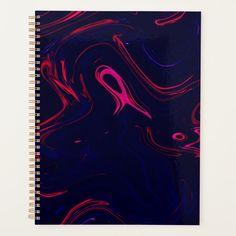 a spiral notebook with pink and blue swirls