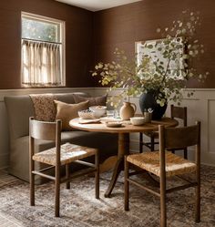 a living room with a couch, table and chairs