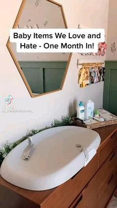 a bathroom sink sitting on top of a wooden dresser