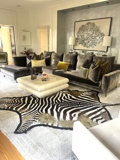 a living room with zebra rugs and couches
