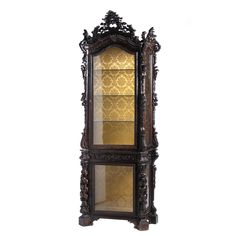 an ornate wooden display case with glass doors