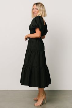 Baltic Born exclusive style Bold black color Cotton material Comfortable relaxed fit Smocked back for a comfortable fit Darling square neckline Classic short puff sleeves with elastic cuffs Functional side pockets Tiered midi skirt Fully lined Self: 100% Cotton Lining: 100% Polyester Marianne is 5'6, cup size 34D, size 6 and wearing size S Modest Black Dress, Black Puff Sleeve Dress, Tiered Midi Skirt, Baltic Born, Black Dress With Sleeves, Square Neck Dress, Short Sleeve Maxi Dresses, Maxi Dress Formal, Feminine Dress