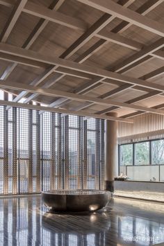 an empty room with lots of windows and wooden slats