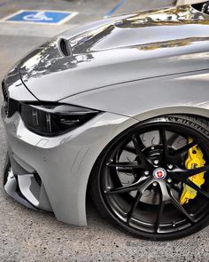 the front end of a grey bmw car