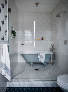 a bath tub sitting next to a toilet in a bathroom