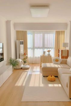 a living room filled with furniture and a flat screen tv on top of a wooden floor