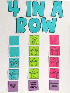 four in a row written on a white board with colorful stickers and stars around it