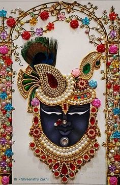 an intricately decorated mask is displayed on a wall