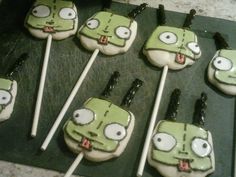 some cake pops with green faces on them