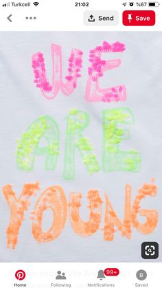 a white t - shirt with the words we are young written in orange and pink