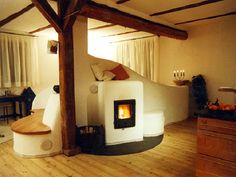 a living room filled with furniture and a fire place in the middle of it's walls