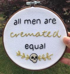 someone is holding up a embroidery hoop with the words, all men are created equal