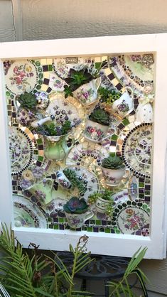 an art piece made out of mosaic tiles and succulents