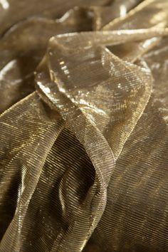 the fabric is shiny and gold in color