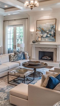 a living room filled with furniture and a fire place under a painting on the wall