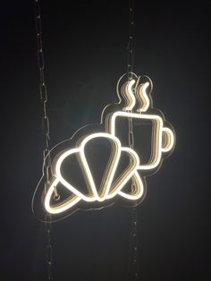 three lights hanging from chains with coffee cups in the shape of mugs on them