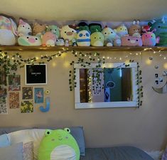 there are many stuffed animals on the shelves above the bed