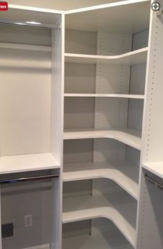 an empty walk in closet with white shelving and no door for the shelves to be opened