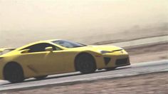 a yellow sports car driving down the road