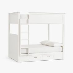 a white bunk bed with two drawers and a pillow on the bottom one is made out of wood