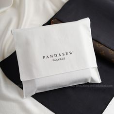 a close up of a pillow on a bed with a name tag attached to it