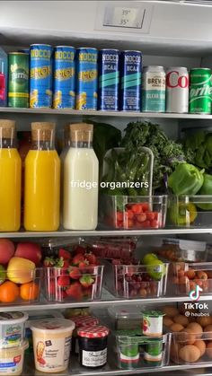 an open refrigerator filled with lots of fresh fruits and vegetables next to juice, yogurt, eggs, milk, and other foods