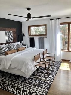 a bedroom with a bed, chair and rug in it's centerpieces