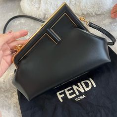 Small Fendi First Bag Made Of Soft, Black Nappa Leather With Oversized Metal F Clasp With Tone On Tone Nappa Leather Bands. Featuring An Internal Compartment Lined In An Iconic Ff Motif Fabric, Pull Out Internal Attachment Points And Gold-Finish Metalware. Can Be Carried By Hand As A Clutch Or Worn On The Shoulder Thanks To The Detachable Shoulder Strap. Made In Italy Composition 100% Lamb Leather, Inside: 27% Polyester, 27% Polyamide, 27% Polyurethane, 15% Cotton, 4% Resin Measurements Height: Fendi First Small, Fendi First Bag, Fendi First, Platform Sandals Heels, Tone On Tone, Fendi Bags, One Bag, Medium Bags, Nappa Leather