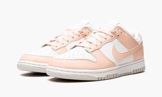 The Women’s Nike Dunk Low Next Nature “Pale Coral” is an easy-wearing colorway of the vintage basketball shoe for women constructed from at least 20% recycled content by weight.  The “Pale Coral” furthers Nike’s “Move to Zero” initiative that aims to reduce the brand’s carbon footprint.  The upper features a white leather construction with contrasting Pale Coral leather overlays and Swoosh branding on the sides.  A two-tone, white midsole and Pale Coral rubber outsole finish off the appealing Du Nature, Jordan Dunk Low, Nike Dunk Low Next Nature, Mid Jordan 1, All Jordans, Logo Nike, Ugg Classic Mini, Nike Dunk High, Rose Pale