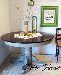 a dining room table with flowers on it and two chairs in front of the table