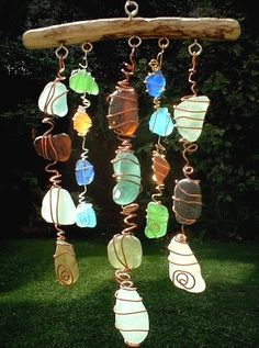 an image of a mobile phone with sea glass beads hanging from it's side