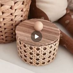a wooden box sitting on top of a table next to a stuffed animal and basket