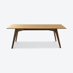 a wooden table with two legs and an oval shaped top, on a white background