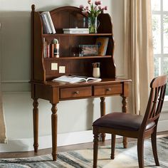 a wooden desk with a chair next to it