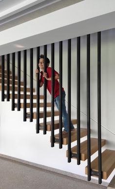 a woman is standing on the stairs with her cell phone